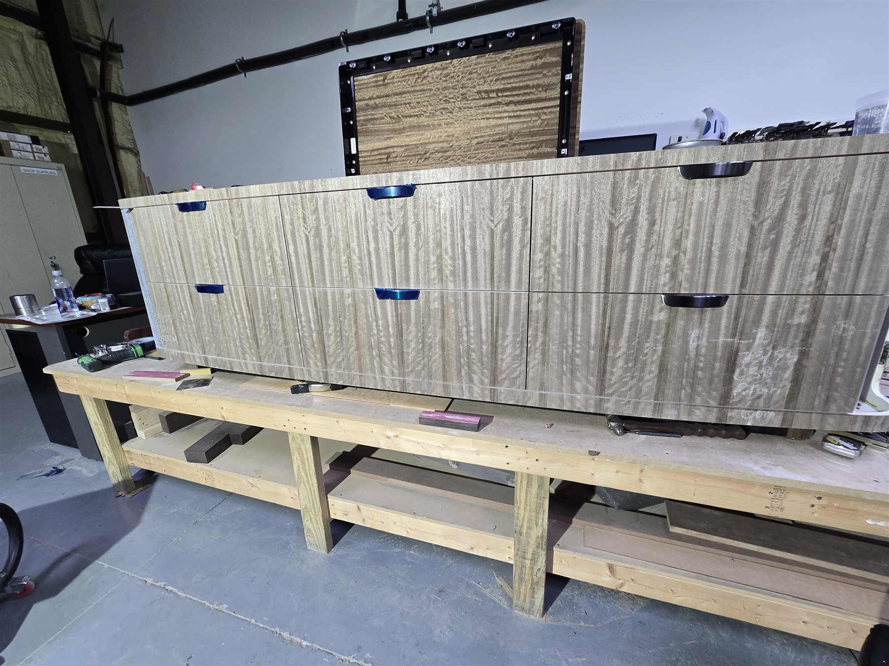Veneered cabinet fronts and curved end detail.