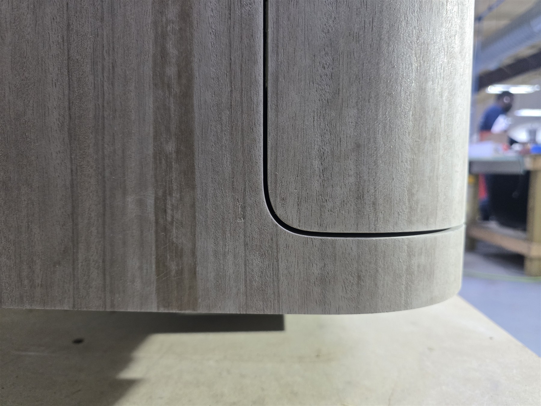 Close-up of veneer following a curved cabinet front